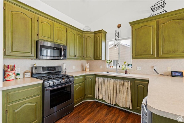 14133 S Lowe Peak Cir, Riverton, UT 84096 - kitchen featuring stainless steel appliances, light countertops, dark wood-type flooring, hanging light fixtures, and decorative backsplash