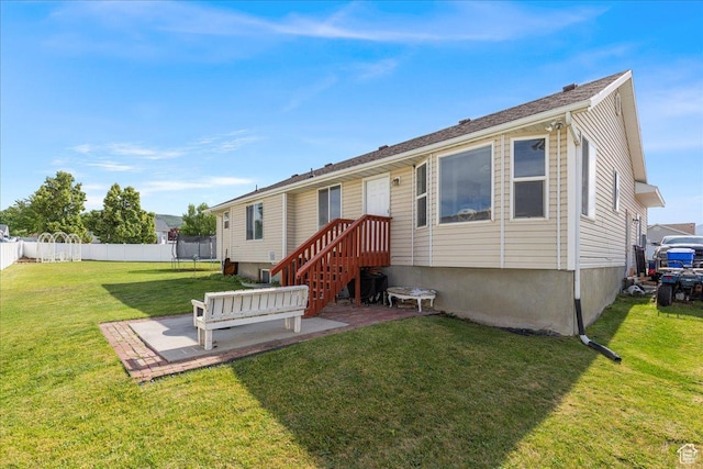 14133 S Lowe Peak Cir, Riverton, UT 84096 - back of property featuring a trampoline and a patio
