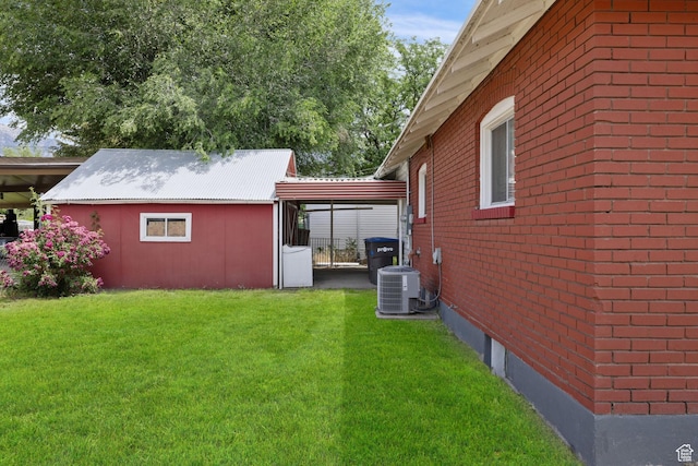 792 W 100 N, Provo, UT 84601 - view of side of home with a lawn, brick siding, an outbuilding, and a carport