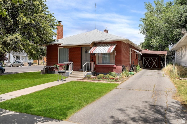 792 W 100 N, Provo, UT 84601 - bungalow-style home with a front yard, a chimney, brick siding, and driveway