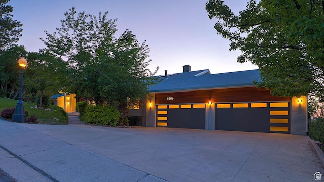 4504 S Abinadi Rd E, Millcreek, UT 84124 - view of front of home featuring a chimney and driveway