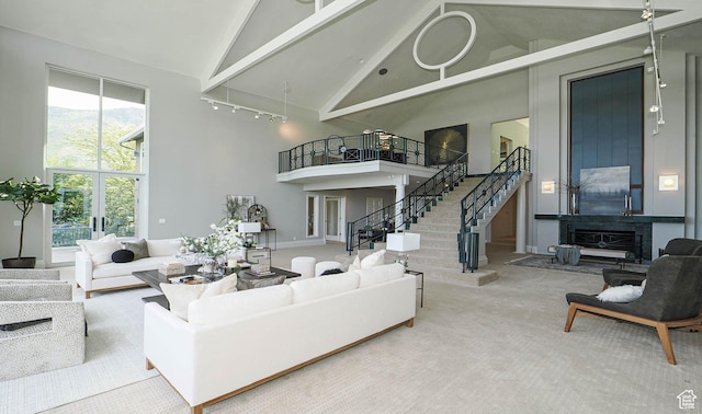 4504 S Abinadi Rd E, Millcreek, UT 84124 - carpeted living room with high vaulted ceiling, stairs, beamed ceiling, and rail lighting