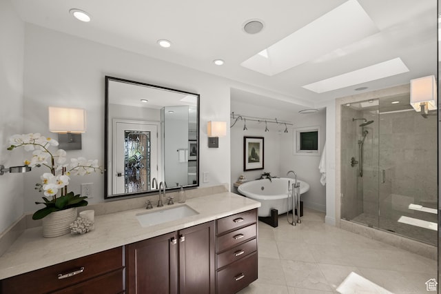 4504 S Abinadi Rd E, Millcreek, UT 84124 - full bath featuring a skylight, a shower stall, vanity, a freestanding tub, and recessed lighting