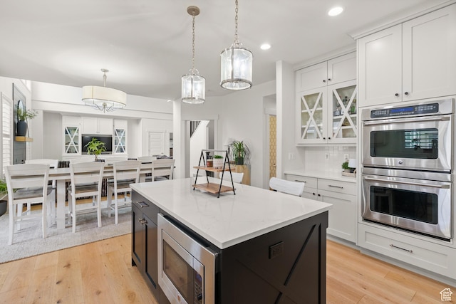 855 E Snap Dragon Ln, Fruit Heights, UT 84037 - kitchen featuring stainless steel appliances, hanging light fixtures, a kitchen island, light wood-style flooring, and recessed lighting