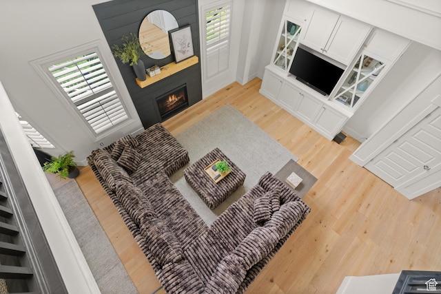 855 E Snap Dragon Ln, Fruit Heights, UT 84037 - living area with light wood-style floors and a lit fireplace