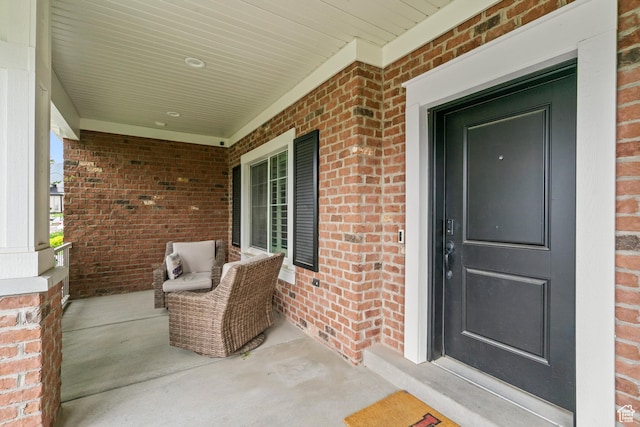 855 E Snap Dragon Ln, Fruit Heights, UT 84037 - view of exterior entry featuring covered porch and brick siding