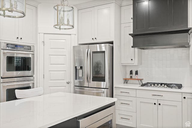 855 E Snap Dragon Ln, Fruit Heights, UT 84037 - kitchen featuring appliances with stainless steel finishes, backsplash, white cabinetry, and wall chimney exhaust hood