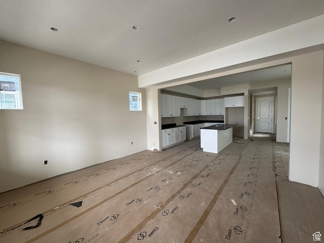 835 S 950 W Unit 124, Springville, UT 84663 - kitchen with white cabinets, dark countertops, healthy amount of natural light, and open floor plan