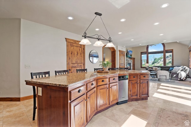 1922 N 1550 E, Provo, UT 84604 - kitchen featuring recessed lighting, a kitchen bar, an island with sink, light tile patterned floors, and decorative light fixtures