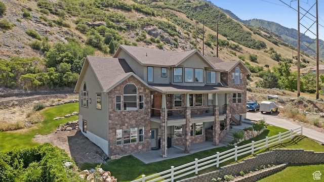 1922 N 1550 E, Provo, UT 84604 - rear view of house featuring stone siding, a patio, stucco siding, and a mountain view