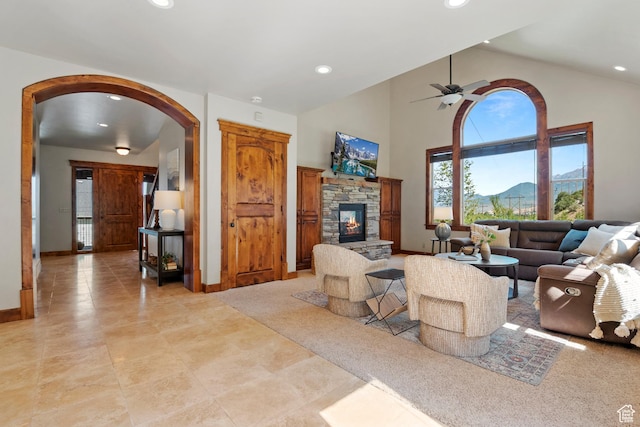 1922 N 1550 E, Provo, UT 84604 - living area with arched walkways, a stone fireplace, recessed lighting, a ceiling fan, and high vaulted ceiling
