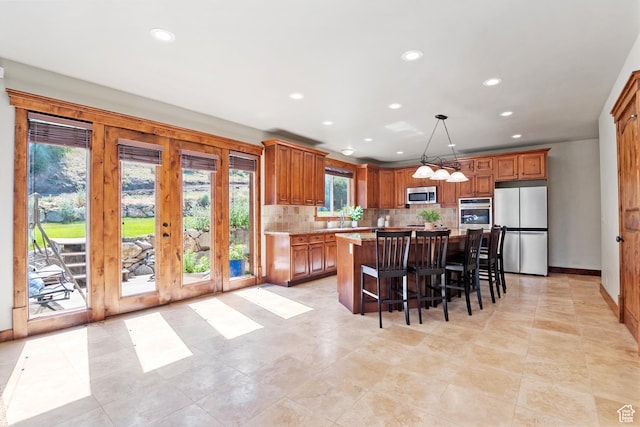 1922 N 1550 E, Provo, UT 84604 - kitchen with stainless steel appliances, recessed lighting, decorative backsplash, a center island, and light countertops