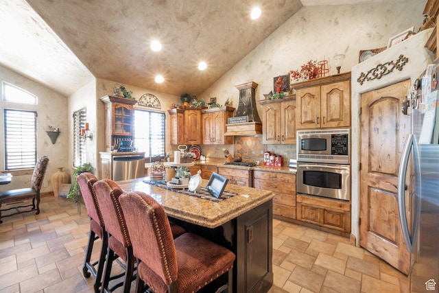 11273 S Alisa Meadows Dr, South Jordan, UT 84095 - kitchen featuring stainless steel appliances, light stone finish floors, custom range hood, light stone countertops, and a kitchen bar
