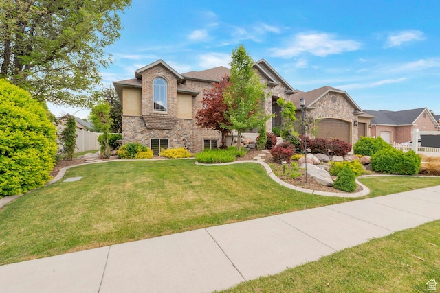 11273 S Alisa Meadows Dr, South Jordan, UT 84095 - view of front of home with stone siding, an attached garage, and stucco siding