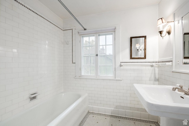 116 S University St E, Salt Lake City, UT 84102 - bathroom with tile walls, a bathtub, tile patterned flooring, and wainscoting