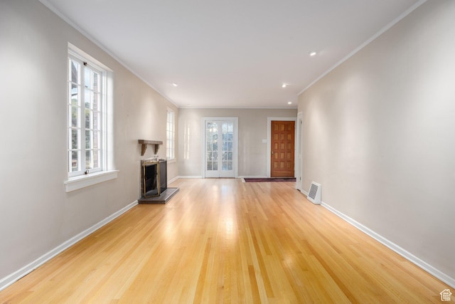 116 S University St E, Salt Lake City, UT 84102 - unfurnished living room with a fireplace with raised hearth, light wood-style floors, crown molding, and recessed lighting