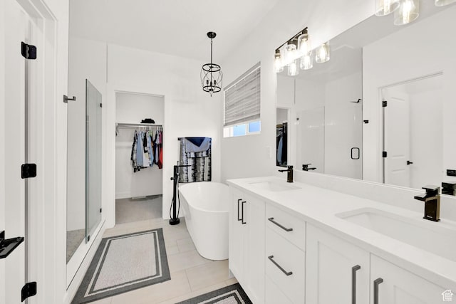 88 N Maraschino W, Grantsville, UT 84029 - bathroom with a stall shower, double vanity, a spacious closet, a soaking tub, and tile patterned floors