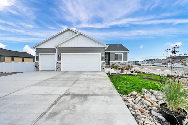 88 N Maraschino W, Grantsville, UT 84029 - view of front of property with stone siding, an attached garage, board and batten siding, and concrete driveway