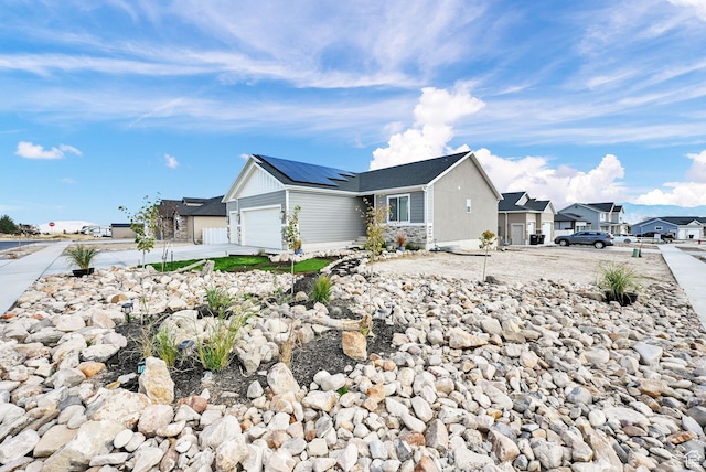 88 N Maraschino W, Grantsville, UT 84029 - view of front of property with a residential view, solar panels, a garage, and concrete driveway