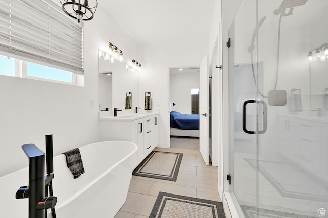 88 N Maraschino W, Grantsville, UT 84029 - ensuite bathroom featuring a stall shower, double vanity, a freestanding bath, and tile patterned floors