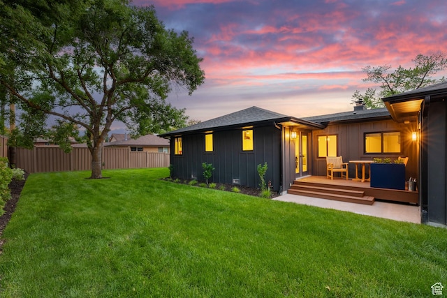 5223 S Hillsden Dr, Holladay, UT 84117 - back of property at dusk with board and batten siding and a deck