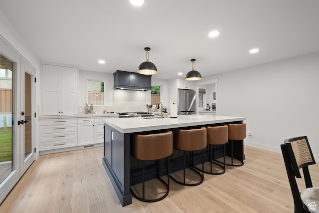 5223 S Hillsden Dr, Holladay, UT 84117 - kitchen featuring stainless steel refrigerator, light countertops, white cabinets, light wood finished floors, and recessed lighting
