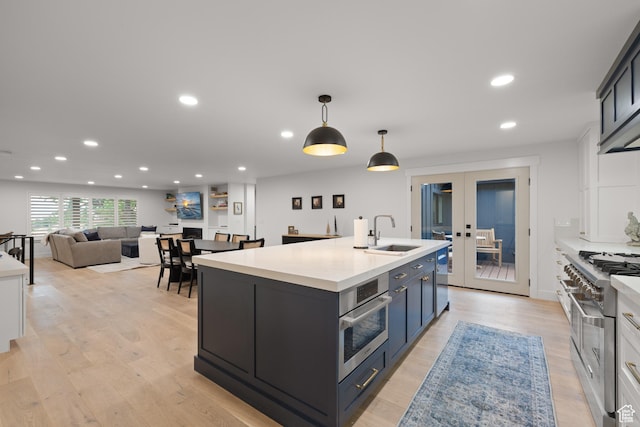5223 S Hillsden Dr, Holladay, UT 84117 - kitchen featuring stainless steel appliances, an island with sink, light countertops, recessed lighting, and decorative light fixtures