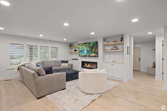 5223 S Hillsden Dr, Holladay, UT 84117 - living room featuring light wood-style flooring, a glass covered fireplace, and recessed lighting