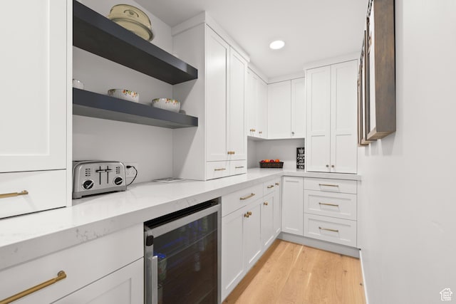5223 S Hillsden Dr, Holladay, UT 84117 - kitchen with wine cooler, white cabinets, light wood finished floors, light stone countertops, and recessed lighting