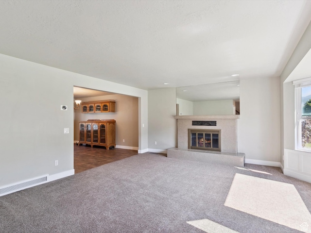 2203 N Joni Dr E, Layton, UT 84040 - unfurnished living room with carpet floors, a glass covered fireplace, and a textured ceiling