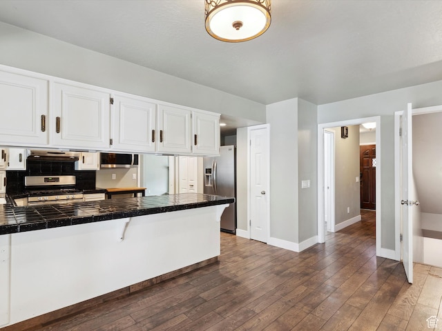 2203 N Joni Dr E, Layton, UT 84040 - kitchen featuring stainless steel appliances, exhaust hood, dark wood-type flooring, white cabinetry, and backsplash