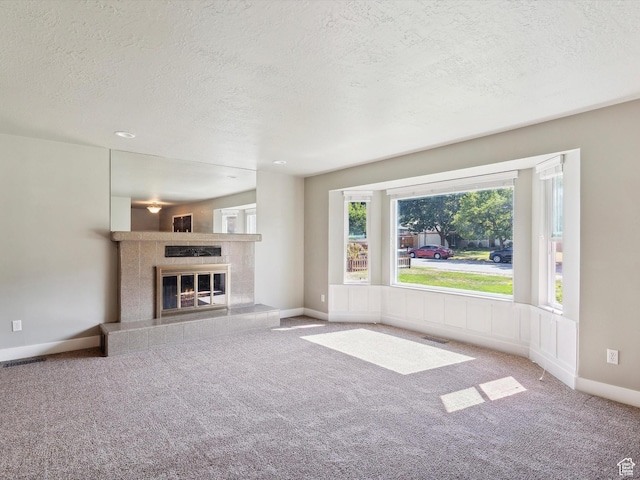 2203 N Joni Dr E, Layton, UT 84040 - unfurnished living room featuring a textured ceiling, carpet flooring, and a tile fireplace