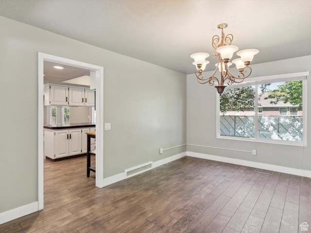 2203 N Joni Dr E, Layton, UT 84040 - empty room featuring a chandelier and dark wood-style floors