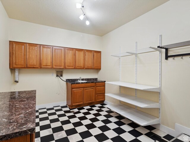 2203 N Joni Dr E, Layton, UT 84040 - washroom with dark floors, cabinet space, washer hookup, track lighting, and a textured ceiling