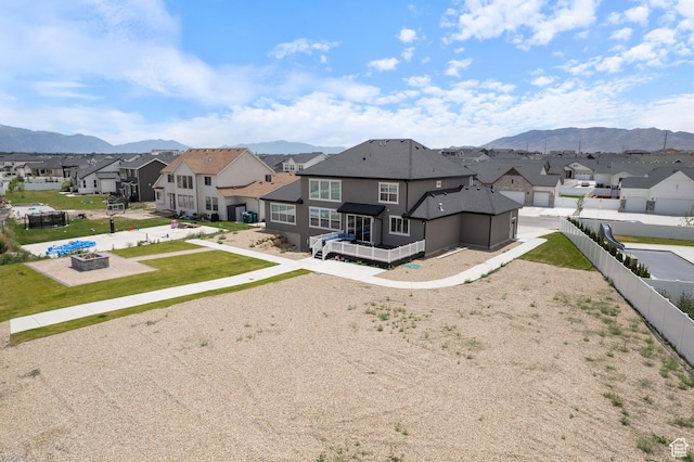 3862 W Lucerne Way, Lehi, UT 84043 - rear view of property featuring a residential view, a fire pit, a mountain view, and a fenced backyard
