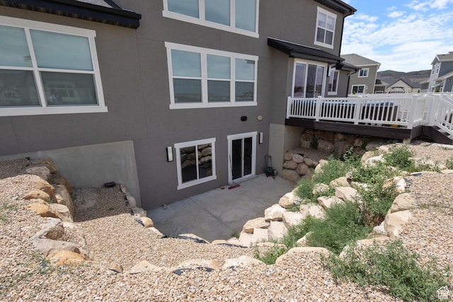 3862 W Lucerne Way, Lehi, UT 84043 - view of home's exterior with stucco siding, a wooden deck, and a patio