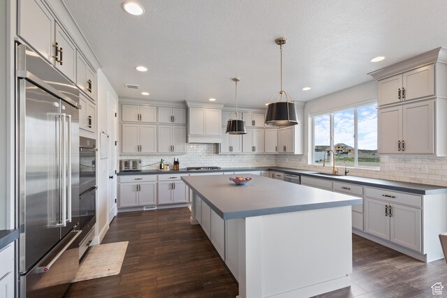 3862 W Lucerne Way, Lehi, UT 84043 - kitchen with stainless steel appliances, dark wood finished floors, decorative backsplash, a center island, and recessed lighting