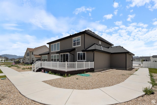 3862 W Lucerne Way, Lehi, UT 84043 - back of property with a residential view, a wooden deck, and stucco siding