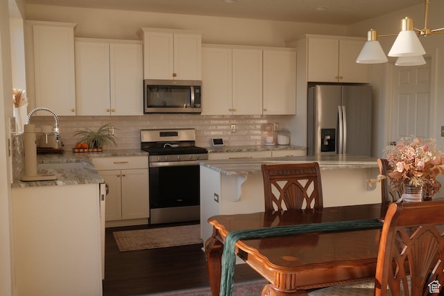 5071 N Oak Creek Dr, Eagle Mountain, UT 84005 - kitchen featuring stainless steel appliances, decorative backsplash, and white cabinetry