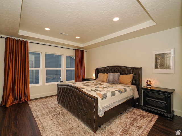 5071 N Oak Creek Dr, Eagle Mountain, UT 84005 - bedroom featuring a tray ceiling, wood finished floors, recessed lighting, and a textured ceiling