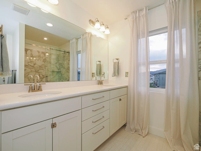 5071 N Oak Creek Dr, Eagle Mountain, UT 84005 - full bathroom featuring double vanity, a marble finish shower, recessed lighting, and tile patterned floors