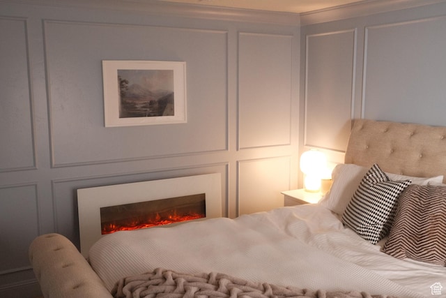 5071 N Oak Creek Dr, Eagle Mountain, UT 84005 - bedroom featuring a decorative wall and a lit fireplace