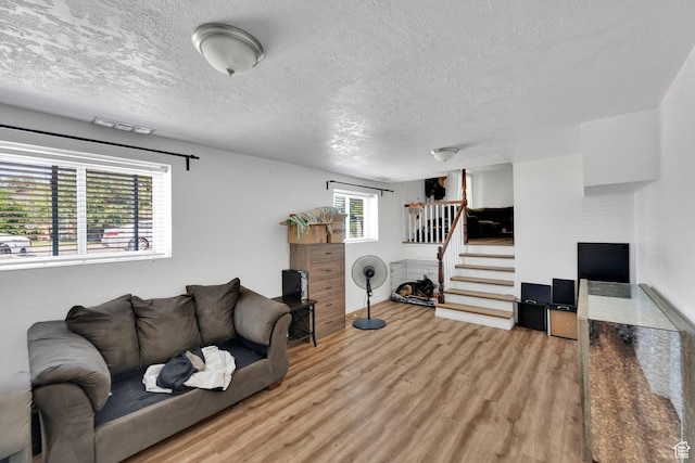 3567 S 3400 W, West Valley City, UT 84119 - living room featuring stairs, wood finished floors, and a textured ceiling