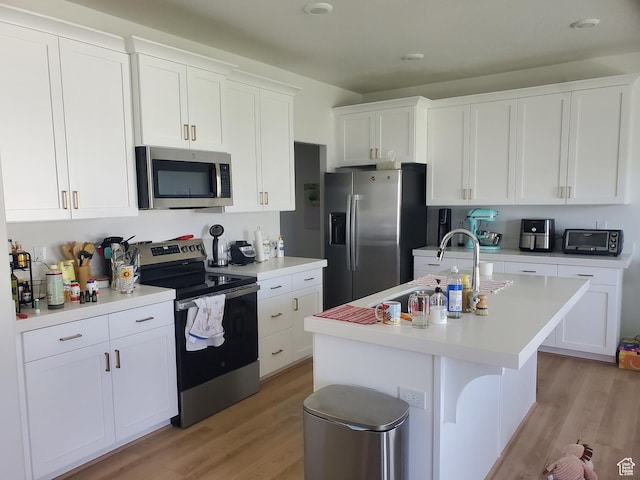 1082 E Springwater Way Unit 812, Eagle Mountain, UT 84005 - kitchen featuring appliances with stainless steel finishes, light wood-style floors, light countertops, and white cabinetry