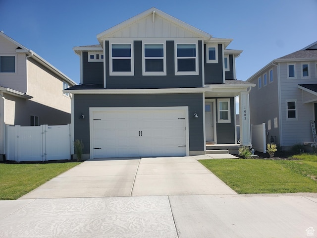 1082 E Springwater Way Unit 812, Eagle Mountain, UT 84005 - traditional-style house with board and batten siding, a garage, concrete driveway, and a gate