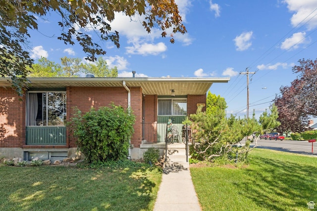 6112 S Vineway Cir E, Salt Lake City, UT 84121 - view of front of house with a front yard, brick siding, and a porch