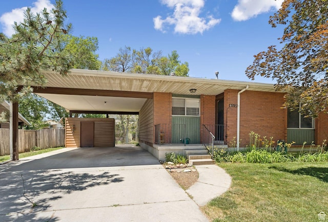 6112 S Vineway Cir E, Salt Lake City, UT 84121 - view of front facade featuring concrete driveway, brick siding, and a carport