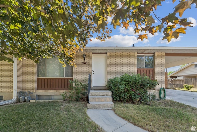 6113 S Vineway Cir, Salt Lake City, UT 84121 - view of front facade featuring brick siding, a carport, and driveway