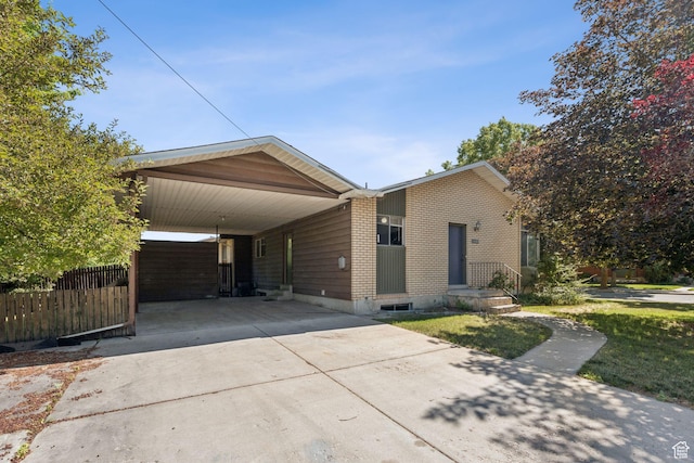 6113 S Vineway Cir, Salt Lake City, UT 84121 - view of front of home with concrete driveway, brick siding, and an attached carport