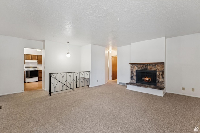 6113 S Vineway Cir, Salt Lake City, UT 84121 - unfurnished living room featuring light carpet, a textured ceiling, and a stone fireplace